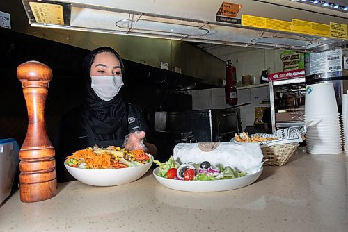 JESSE BOILY  / WINNIPEG FREE PRESS
Masoomeh Jafari serves up some of the food at the Next Stop Cafe on Friday. The restaurant hosts a variety of foods from 14 different types of burgers to Iranian street food. Friday, Oct. 2, 2020.
Reporter:Alison Gillmor