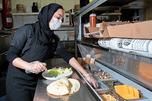 JESSE BOILY  / WINNIPEG FREE PRESS
Masoomeh Jafari prepares a plate at the Next Stop Cafe on Friday. The restaurant hosts a variety of foods from 14 different types of burgers to Iranian street food. Friday, Oct. 2, 2020.
Reporter:Alison Gillmor
