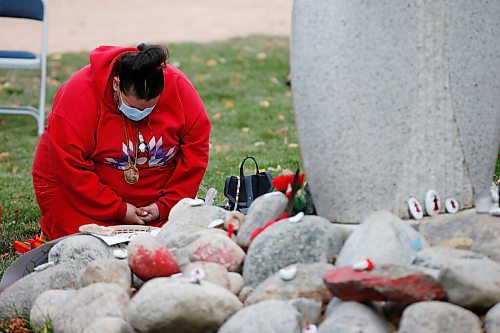 JOHN WOODS / WINNIPEG FREE PRESS
A person takes a quiet moment at the monument for Murdered and Missing Indigenous Women and Girls (MMIWG) on Red Dress Day at the Forks in Winnipeg Sunday, October 4, 2020. 

Reporter: Katie