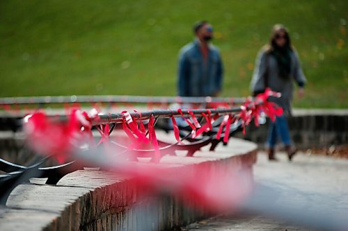 JOHN WOODS / WINNIPEG FREE PRESS
Billy and Kathleen Lapointe walk past red ribbons which were placed for Murdered and Missing Indigenous Women and Girls (MMIWG) on Red Dress Day at the Forks in Winnipeg Sunday, October 4, 2020. 

Reporter: Katie