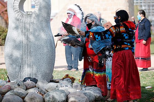 JOHN WOODS / WINNIPEG FREE PRESS
People gather at the monument for Murdered and Missing Indigenous Women and Girls (MMIWG) on Red Dress Day at the Forks in Winnipeg Sunday, October 4, 2020. 

Reporter: Katie