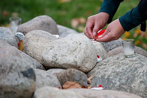 JOHN WOODS / WINNIPEG FREE PRESS
People gather and place tobacco at the monument for Murdered and Missing Indigenous Women and Girls (MMIWG) on Red Dress Day at the Forks in Winnipeg Sunday, October 4, 2020. 

Reporter: Katie