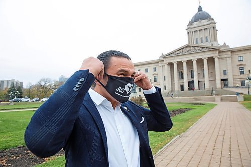 MIKE DEAL / WINNIPEG FREE PRESS
Manitoba NDP leader of the opposition, Wab Kinew puts on a mask before speaking at the Justice for PS 752 rally at the Manitoba Legislative building Monday morning which was part of a worldwide rally happening at the same time. 
201005 - Monday, October 05, 2020.