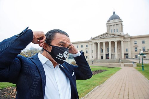 MIKE DEAL / WINNIPEG FREE PRESS
Manitoba NDP leader of the opposition, Wab Kinew puts on a mask before speaking at the Justice for PS 752 rally at the Manitoba Legislative building Monday morning which was part of a worldwide rally happening at the same time. 
201005 - Monday, October 05, 2020.