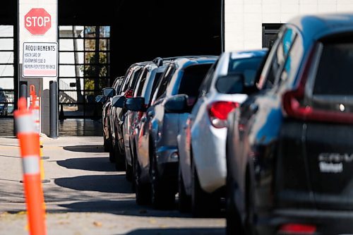 Daniel Crump / Winnipeg Free Press. Vehicles snake around the parking lot at the drive-in COVID test site on Main Street in the North End. October 10, 2020.