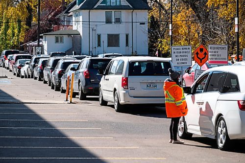 Daniel Crump / Winnipeg Free Press. Vehicles snake around the parking lot at the drive-in COVID test site on Main Street in the North End. October 10, 2020.