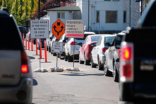 Daniel Crump / Winnipeg Free Press. Vehicles snake around the parking lot at the drive-in COVID test site on Main Street in the North End. October 10, 2020.