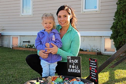 Canstar Community News Ashley Kabel and her daughter Octavia pose beside The Rock & Roll Garden on Oct. 6. Kabel and her family painted many of the rocks in the garden, which was unveiled on Sept. 29. (GABRIELLE PICHE/CANSTAR COMMUNITY NEWS/HEADLINER)