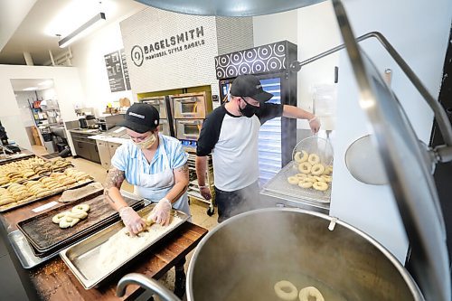 RUTH BONNEVILLE / WINNIPEG FREE PRESS

BIZ - Bagelsmith

Photo of Bagelsmith owner, Phil Klein, making his traditional Montreal bagels in his shop on Carlton.  Manager Jenn Kostesky also makes bagels and is an integral part of the operation. 

Since May, Phil Kleins Bagelsmith restaurant has sold over 100,000 bagels. One hundred thousand bagels. And they didnt even open their physical shop until this week! Through online sales, the start-up bagel shop on Carlton Street has struck gold. They also have distribution at Piazza de Nardi and at Myers Delicatessen.


Reporter: Ben Waldman

Oct 20th, 2020