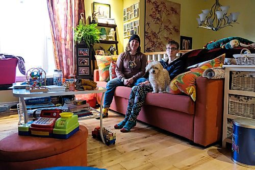 Daniel Crump / Winnipeg Free Press. (L to R) Sisters Madison and Teagan¤Zienkiewicz sit on a couch with their dog Bijou in their St. Vital home. Teagan, who has autism, isnt able to attend her day program due to safety concerns related to the coronavirus pandemic. October 22, 2020.