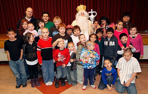 BORIS.MINKEVICH@FREEPRESS.MB.CA BORIS MINKEVICH/ WINNIPEG FREE PRESS  091215 The Welcome Home inner city mission had an event at St. Andrews Church(160 Euclid) for kids in the area. Father Michael Smolinski (far left top) and old Saint Nick posed for a photo with the kids.