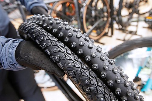 JOHN WOODS / WINNIPEG FREE PRESS
Emily Payne, a staffer at Bikes And Beyond, who has been winter riding for the past three years in Winnipeg is photographed Thursday, October 29, 2020. She show some studded tires which would be helpful for snow and ice conditions.

Reporter: Waldman