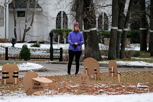 Daniel Crump / Winnipeg Free Press. A person reacts as they stop to read cardboard tombstones setup outside Manitoba Premier Brian Pallisters Wellington Crescent home. October 31, 2020.