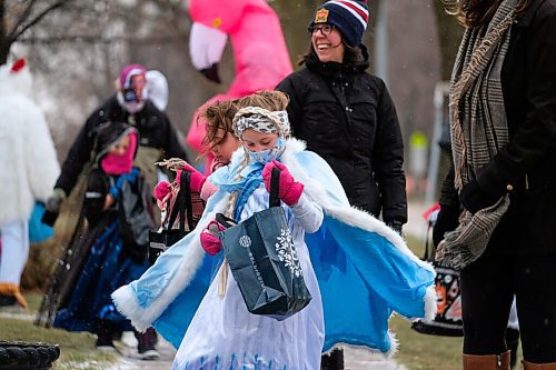 Daniel Crump / Winnipeg Free Press. Madison Dragner, dressed in an Elsa costume, checks her haul of candy during a special COVID safe halloween event on Elm Street. October 31, 2020.