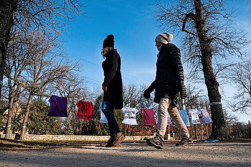 Daniel Crump / Winnipeg Free Press. People walk by a protest art instalment on the boulevard at wellington crescent set up by concerned health care workers. November 7, 2020.