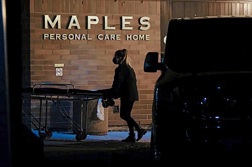 Daniel Crump / Winnipeg Free Press. A person from the coroners office wheels a stretcher into the Maples Personal Care Home. The Winnipeg care home is the site of a COVID-19 outbreak. November 7, 2020.