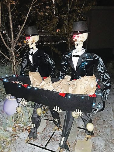 Canstar Community News One East Kildonan homeowner offered treat bags on a coffin-shaped hors doeuvres tray held by two skeletons in evening dress.
