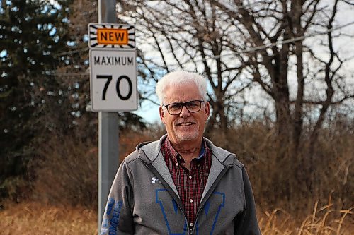 Canstar Community News Dan McInnis stands beside a sign showing Roblin Boulevard's new speed limit on Nov. 2. (GABRIELLE PICHE/CANSTAR COMMUNITY NEWS/HEADLINER)