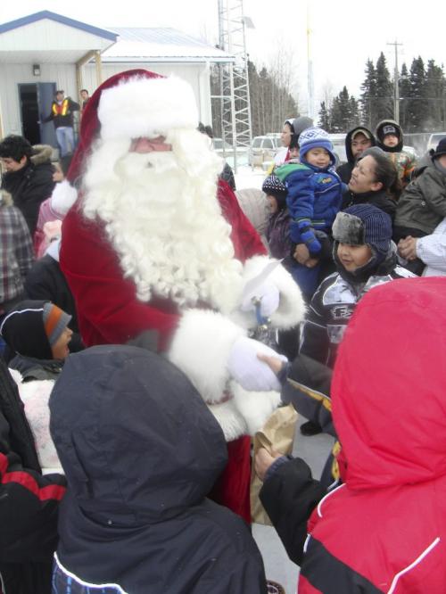 Photo 142: Santa meeting the swarm of people at Gods Lake Narrows shelley cook winnipeg free press