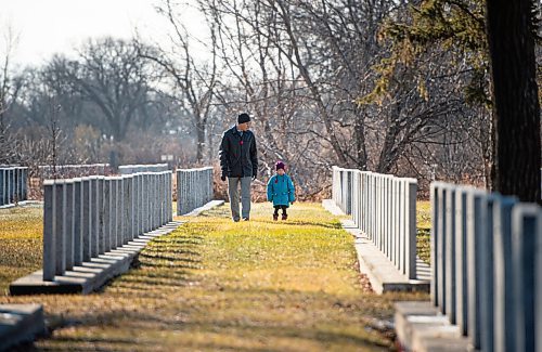 Mike Sudoma / Winnipeg Free Press
Derek Zaporzan and his Daughter (name withheld) walk amongst the gravestones in the Field of Honour as they pay their respects prior to a Remembrance Day bagpipe ceremony at Brookside Cemetery Wednesday morning
November 11, 2020