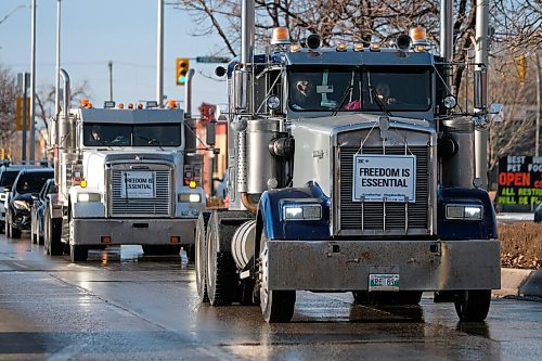 Daniel Crump / Winnipeg Free Press. A Hugs Over Masks anti-masker convey rolls down Main Street in Steinbach. November 14, 2020.