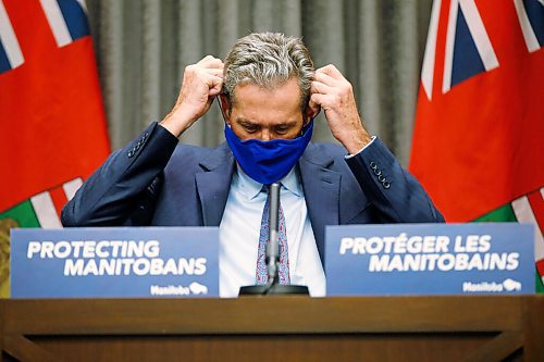 JOHN WOODS / WINNIPEG FREE PRESS
Premier Brian Pallister puts on his mask after speaking to media during a COVID-19 press conference at the Manitoba Legislature in Winnipeg Monday, November 16, 2020. Pallister announced funding for small businesses.

Reporter: ?