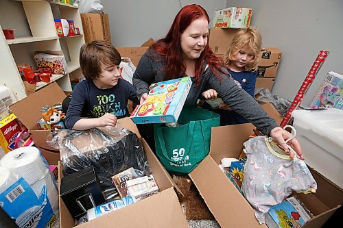 JOHN WOODS / WINNIPEG FREE PRESS
Nicole Jung and her children Ben and Annie pack hampers in their basement in Winnipeg Wednesday, November 18, 2020. Jung decided to pack hampers for Christmas after hearing the Christmas Cheer Board may not be giving out hampers this year.

Reporter: Kellen