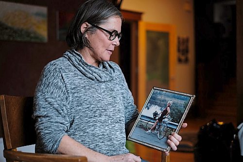 Daniel Crump / Winnipeg Free Press. Lilian Bonin holds a photo of her mother, Christine Bonin, as she recalls a cycling trip to Vermont that the two did together 30 years ago. Lilian said of her mother, "She lived a full life and was my best friend.. November 21, 2020.