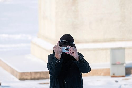 Daniel Crump / Winnipeg Free Press. An anti-mask protestor flips the finger at members of the media during a a small protest of about a dozen people at the Manitoba Legislature. November 21, 2020.