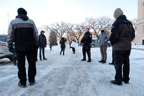 Daniel Crump / Winnipeg Free Press. Police officers ask a small group of anti-mask protestors to disperse as they gather at the Manitoba Legislature. November 21, 2020.