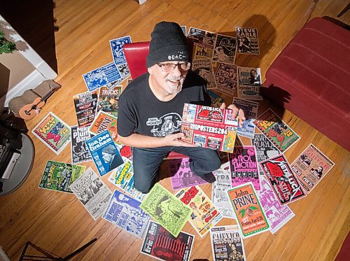 Mike Sudoma / Winnipeg Free Press
Stu Reid aka Stu Art holds up his newly released Gig Posters calendar, while being surrounded by just a few of the posters hes designed over the years.
November 24, 2020