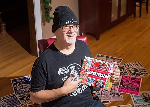 Mike Sudoma / Winnipeg Free Press
Stu Reid aka Stu Art holds up his newly released Gig Posters calendar, while being surrounded by just a few of the posters hes designed over the years.
November 24, 2020