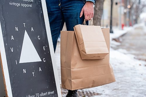 Mike Sudoma / Winnipeg Free Press
Vantage Vintage co-owner Michael Duchon holds delivery bags filled with vintage wear purchased online, outside of their shop on Albert St Wednesday morning
November 25, 2020