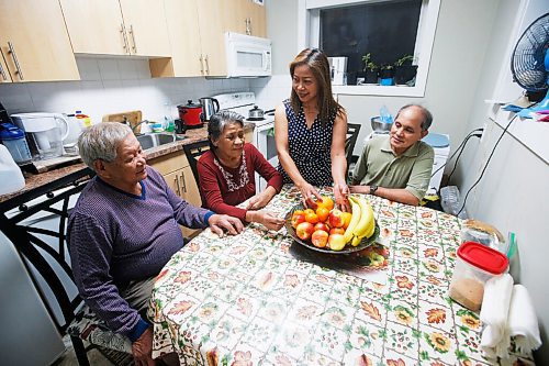 JOHN WOODS / WINNIPEG FREE PRESS
Amy Lania, centre, and her husband Sil, right, are photographed with her parents Gavino and Mely Sernadilla in their home in Winnipeg Wednesday, November 25, 2020. Lania, a live-in nanny, lives with her husband and parents and sends $500 remittance to her children and grandchildren in the Philippines.

Reporter: Abas