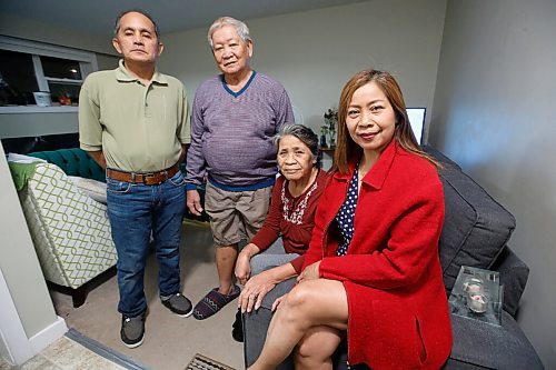 JOHN WOODS / WINNIPEG FREE PRESS
Amy Lania, right, and her husband Sil, left, are photographed with her parents Gavino and Mely Sernadilla in their home in Winnipeg Wednesday, November 25, 2020. Lania, a live-in nanny, lives with her husband and parents and sends $500 remittance to her children and grandchildren in the Philippines.

Reporter: Abas