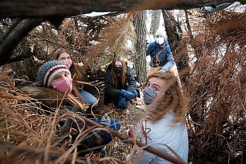 JOHN WOODS / WINNIPEG FREE PRESS
Tim Morison, a phys. ed. teacher at Starbuck School in Starbuck is photographed with students, from left, Anjali Smelski Zuk, Myriam Duval, Isabel Fischer and Kiera Mosset in their survival shelter Thursday, November 26, 2020. Morison has moved his class outside and created some interesting programming which includes winter survival and shovelling snow for local seniors.

Reporter: McIntosh