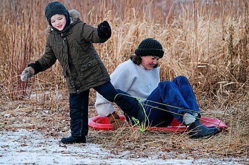 Daniel Crump / Winnipeg Free Press. 5-year-old Ellis Peters and his mom, Christie Peters, disentangle themselves from their sled after a run down the hill at Halter Park. November 28, 2020.