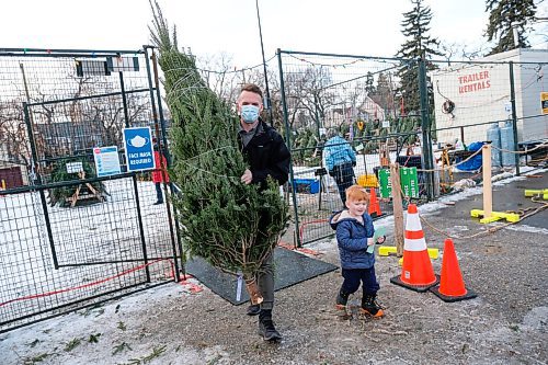 Daniel Crump / Winnipeg Free Press. Nathan Zahn and son Nova carry away their Christmas tree at the 67th Scout Group tree lot in River Heights. Because of pandemic restrictions Christmas trees have to be preordered and are only available for curtsied pickup. November 28, 2020.