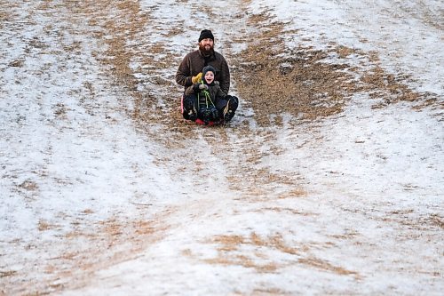 Daniel Crump / Winnipeg Free Press. Evan Peters speeds down the hill at Halter Park with his son Ellis. The Peters family was out enjoying the mild late fall weather. November 28, 2020.
