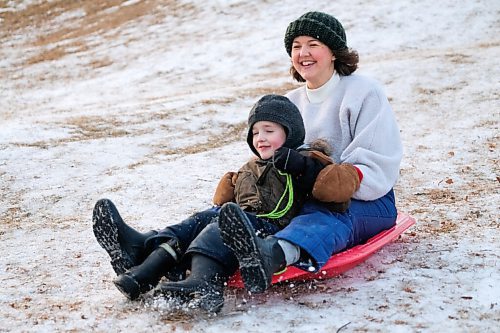 Daniel Crump / Winnipeg Free Press. Christie Peters and her son Ellis ride their sled down the hill at Halter Park. The Peters family spent their afternoon enjoying the mild later fall weather. November 28, 2020.