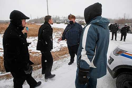 JOHN WOODS / WINNIPEG FREE PRESS
RCMP officers and Manitoba Justice officials talk to and let the pastor pass as they turn people away and blocked the entrance to Church of God Restoration in Sarto, just south of Steinbach, to enforce Manitoba Health COVID-19 orders Sunday, November 29, 2020. 

Reporter: Abas