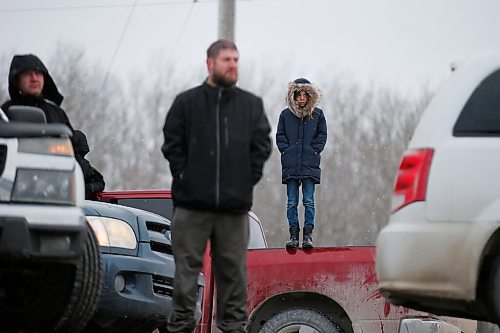 JOHN WOODS / WINNIPEG FREE PRESS
Parishioners look on as their pastor speaks from a truck  and RCMP officers and Manitoba Justice officials blocked the entrance to Church of God Restoration in Sarto, just south of Steinbach, to enforce Manitoba Health COVID-19 orders Sunday, November 29, 2020. 

Reporter: Abas
