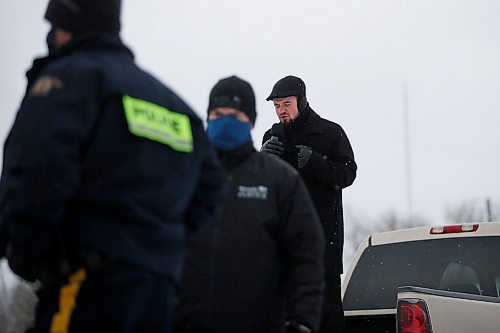 JOHN WOODS / WINNIPEG FREE PRESS
Church of God Restoration pastor Tobias Tissen speaks from a truck as RCMP officers and Manitoba Justice officials blocked the entrance to Church of God Restoration in Sarto, just south of Steinbach, to enforce Manitoba Health COVID-19 orders Sunday, November 29, 2020. 

Reporter: Abas