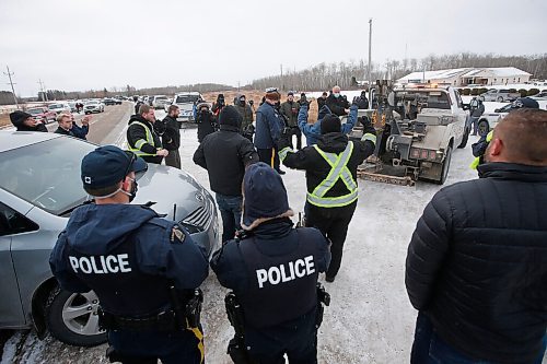 JOHN WOODS / WINNIPEG FREE PRESS
People cheer as a tow truck is removed as RCMP officers and Manitoba Justice officials blocked the entrance to Church of God Restoration in Sarto, just south of Steinbach, to enforce Manitoba Health COVID-19 orders Sunday, November 29, 2020. 

Reporter: Abas