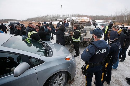 JOHN WOODS / WINNIPEG FREE PRESS
People pray as a tow truck is moved in to remove a van as RCMP officers and Manitoba Justice officials blocked the entrance to Church of God Restoration in Sarto, just south of Steinbach, to enforce Manitoba Health COVID-19 orders Sunday, November 29, 2020. 

Reporter: Abas