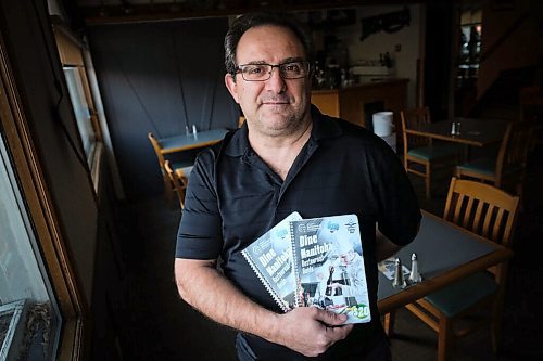 Daniel Crump / Winnipeg Free Press. Joe Loschiavo, owner Pasquale's Ristorante, with a mock-up of an Entertainment type coupon book that is being released next week, to help restaurateurs through the Code Red shutdown. November 30, 2020.