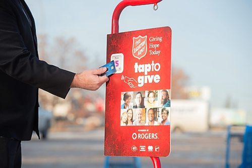 Mike Sudoma / Winnipeg Free Press
Salvation Army Officer, Jamie Rands, demonstrates how to use the charitys new Tap to Give system Friday afternoon. This system will replace the donation kettles theyve used in the past, allowing donors give donations handsfree.
December 4, 2020