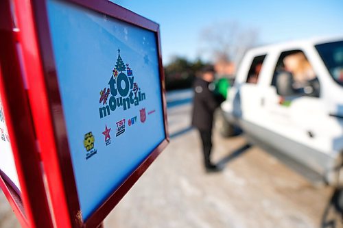 Daniel Crump / Winnipeg Free Press. A person drops off a donation of toys for the Salvations Armys drive-in toy donation location at ToysRUs Polo Park. The annual Toy Mountain event is being held as a drive-in this year do to the coronavirus pandemic. December 5, 2020.