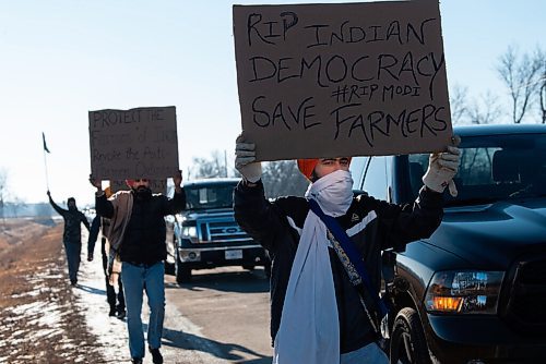 JESSE BOILY  / WINNIPEG FREE PRESS
A demonstrator walks past some cars while chanting support for the Kissan Rally in support of farmers on Sunday. Cars lined Mollard rd, and Pipeline Rd and looped around on the Perimeter highway. Sunday, Dec. 6, 2020.
Reporter: Ryan Thorpe