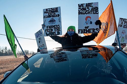 JESSE BOILY  / WINNIPEG FREE PRESS
A demonstrator stands through the sun roof of a car to show their support at the Kissan Rally in support of farmers on Sunday.   Sunday, Dec. 6, 2020.
Reporter: Ryan Thorpe